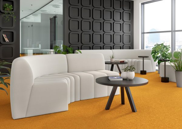 sile commercial sofa with channeled seat and smooth upholstered back in an office